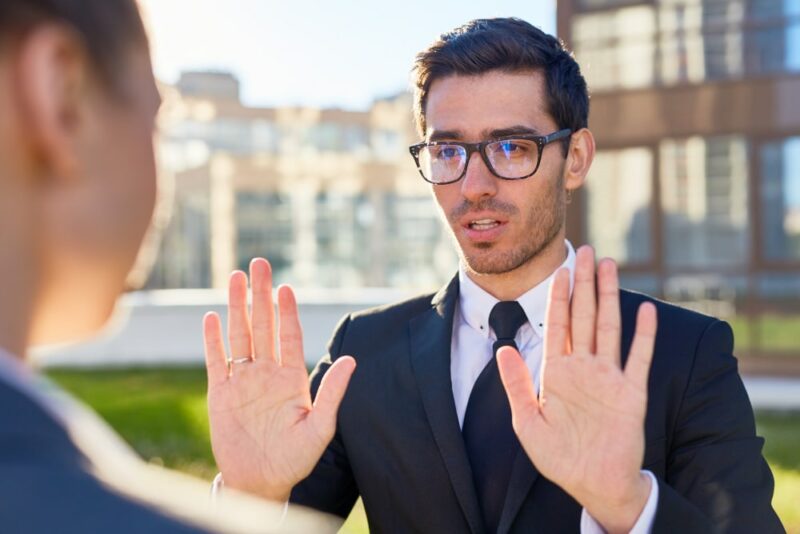 homme qui refuse les mains devant